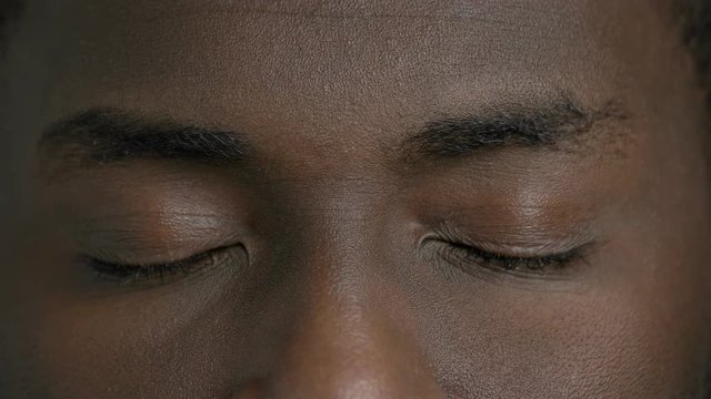 Afro-american man closed eyes close up. Face of black man close up.