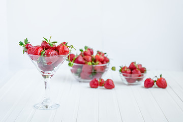 Fresh strawberries in a bowl on a white background.