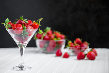 Fresh strawberries in a bowl on a white background.
