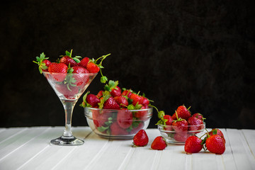 Fresh strawberries in a bowl on a white background.