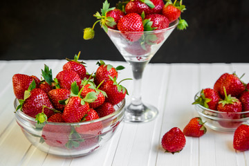 Fresh strawberries in a bowl on a white background.