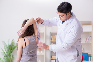 Doctor checking patients joint flexibility