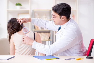Doctor checking patients joint flexibility with gonimeter