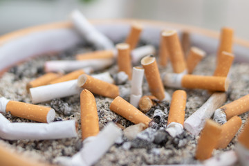 many cigarette butts in an ashtray