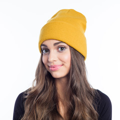 Happy long hair young woman in yellow beanie hat
