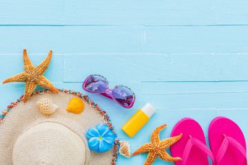 Beach accessories including sunglasses, starfish, hat beach, sunblock, colorful flip flop and shell...