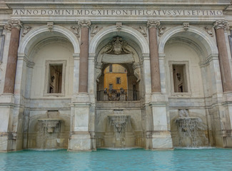 Obraz premium Rome, Lazio, Italy - September 10, 2017: Front view of a fountain in Rome with three arches and water at the bottom