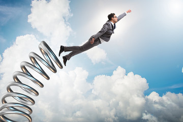 Businessman jumping from spring in promotion concept