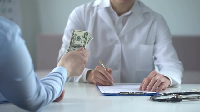 Doctor writing fake medical examination, taking bribe, expensive checkups