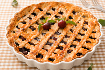 Delicious cherry pie on kitchen table