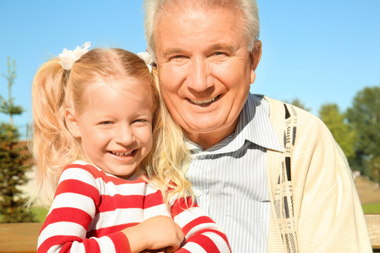 Elderly man with granddaughter in park