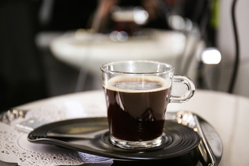 Tray with cup of coffee on table indoors, closeup
