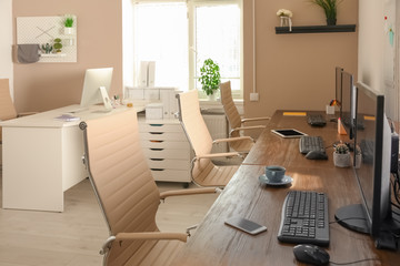 Stylish workplace interior with computers on tables