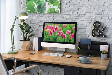 Stylish workplace with computer on table