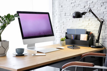 Stylish workplace with computer on table