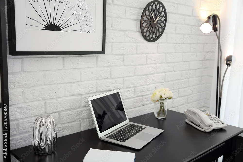 Poster Stylish workplace interior with laptop on table