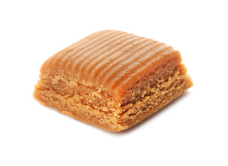 Delicious caramel candy on white background
