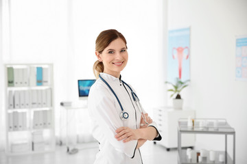 Smiling female doctor wearing uniform in modern hospital. Gynecology consultation