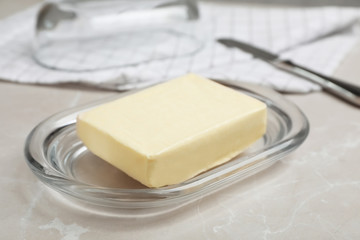 Plate with tasty fresh butter on table
