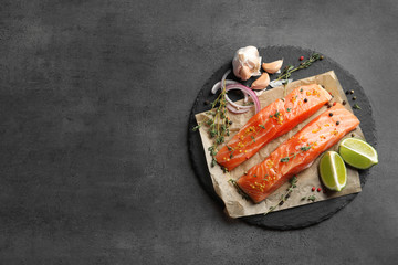 Fresh salmon and ingredients for marinade on slate plate