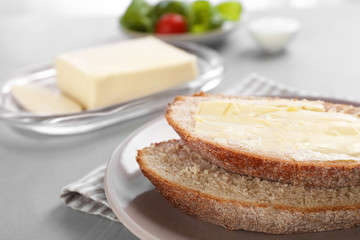 Fresh bread with tasty butter on plate