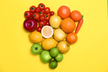 Rainbow composition with ripe fruits and vegetables on color background, top view
