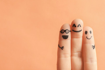 Fingers with drawings of happy faces against color background. Unity concept - obrazy, fototapety, plakaty