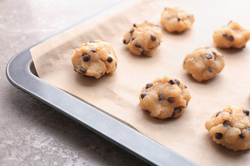 Cookie dough with chocolate chips on baking sheet, closeup