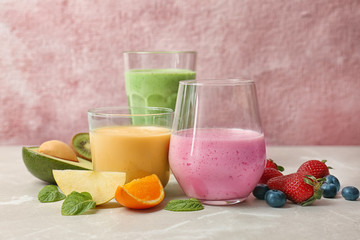 Glasses with healthy detox smoothies and ingredients on table