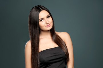 Portrait of beautiful model with gorgeous straight hair on color background