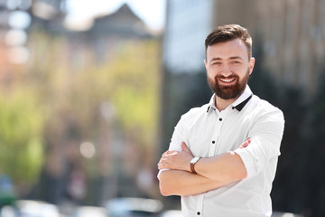 Portrait of young man in stylish outfit outdoors