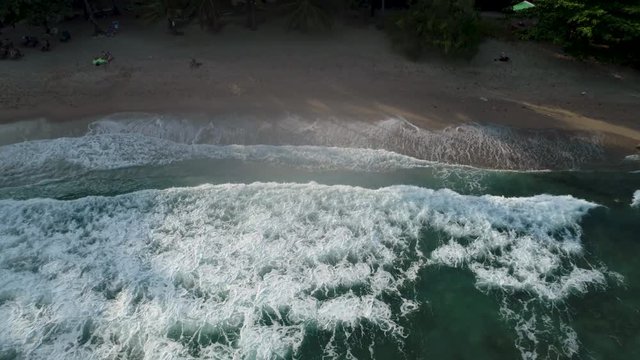 Drone footage. Thailand. Koh Phangan island. Haad tien beach. Top view aerial video of beauty nature landscape with beach, sea and jungle.