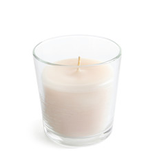 Glass with wax candle on white background