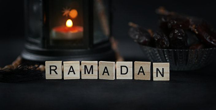Ramadan Greeting Scrabble Letters. Ramadan Candle Lantern with Wooden Prayer Beads and Dates