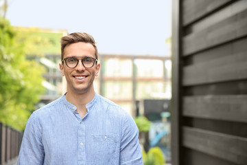 Obraz premium Portrait of attractive young man in stylish outfit outdoors