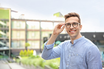 Portrait of attractive young man in stylish outfit outdoors