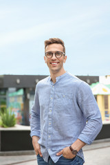 Portrait of attractive young man in stylish outfit outdoors