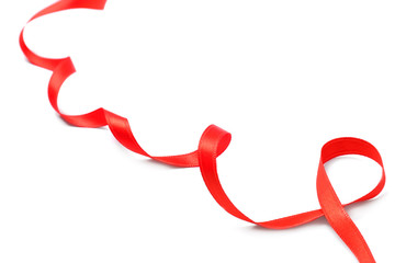 Simple red ribbon on white background, closeup