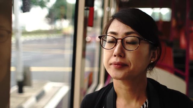 バスに乗っているアジア女性