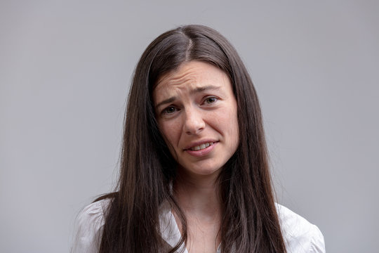 Young long-haired brunette with wry face