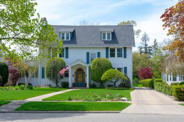 Front view of traditional colonial home with blue shutters - 205705642