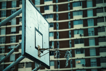 Basketball hoop agianst buildings.