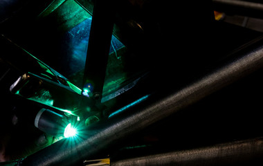 Man tig welding with brilliant bright white star burst blooms