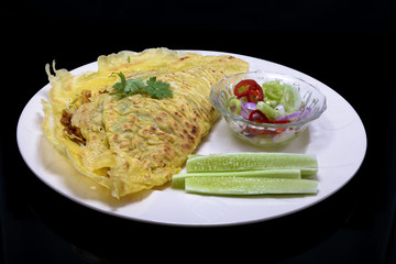 Vietnamese food. Kanom Buang Yuan or Vietnamese stuffed crispy omelette  served with Acar dipping sauce. selective focus. III
