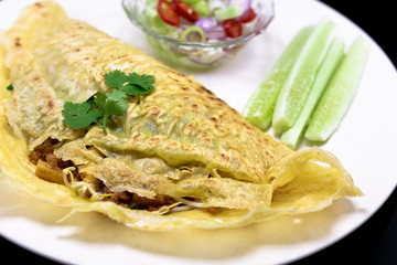 Vietnamese food. Kanom Buang Yuan or Vietnamese stuffed crispy omelette  served with Acar dipping sauce. selective focus.
