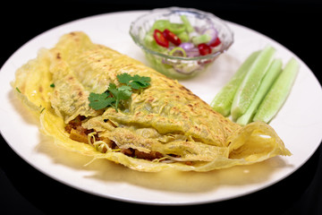 Vietnamese food. Kanom Buang Yuan or Vietnamese stuffed crispy omelette  served with Acar dipping sauce. selective focus. III