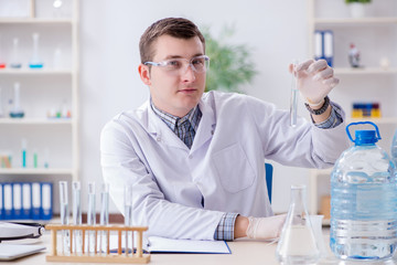 Young chemist student experimenting in lab