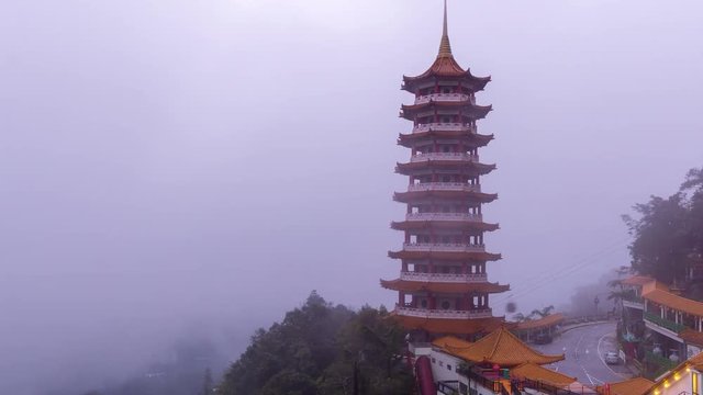 GENTING, MALAYSIA - 10th MAC 2018; 4K Time lapse of moving clouds and fog over Chin Swee Caves Temple in Malaysia. Zoom In.