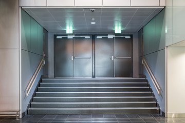 Fire exit metallic doors with staircase - obrazy, fototapety, plakaty