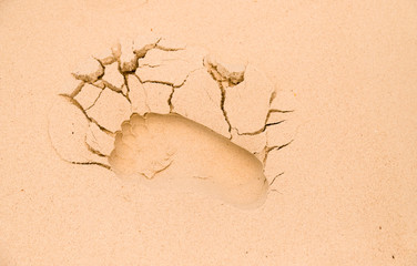 Closeup of cracked footprint on the beach.